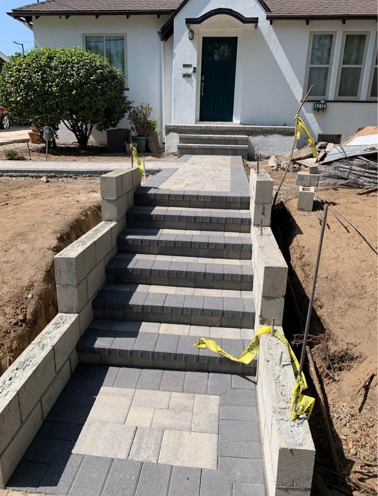 Finished two-tone paver entry steps with retaining walls and landing