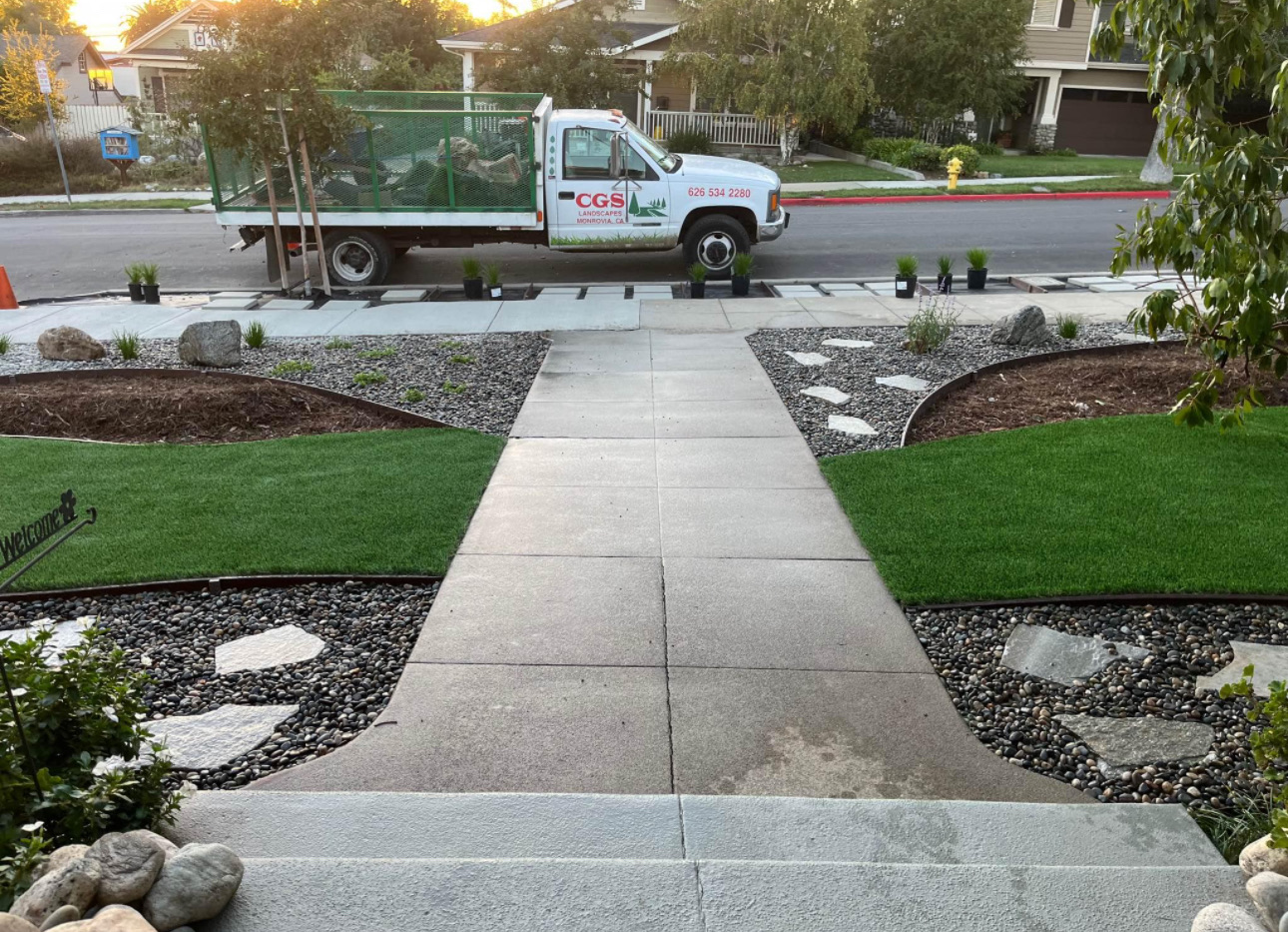 Finished front yard with turf panels, river rock beds and flagstone accents