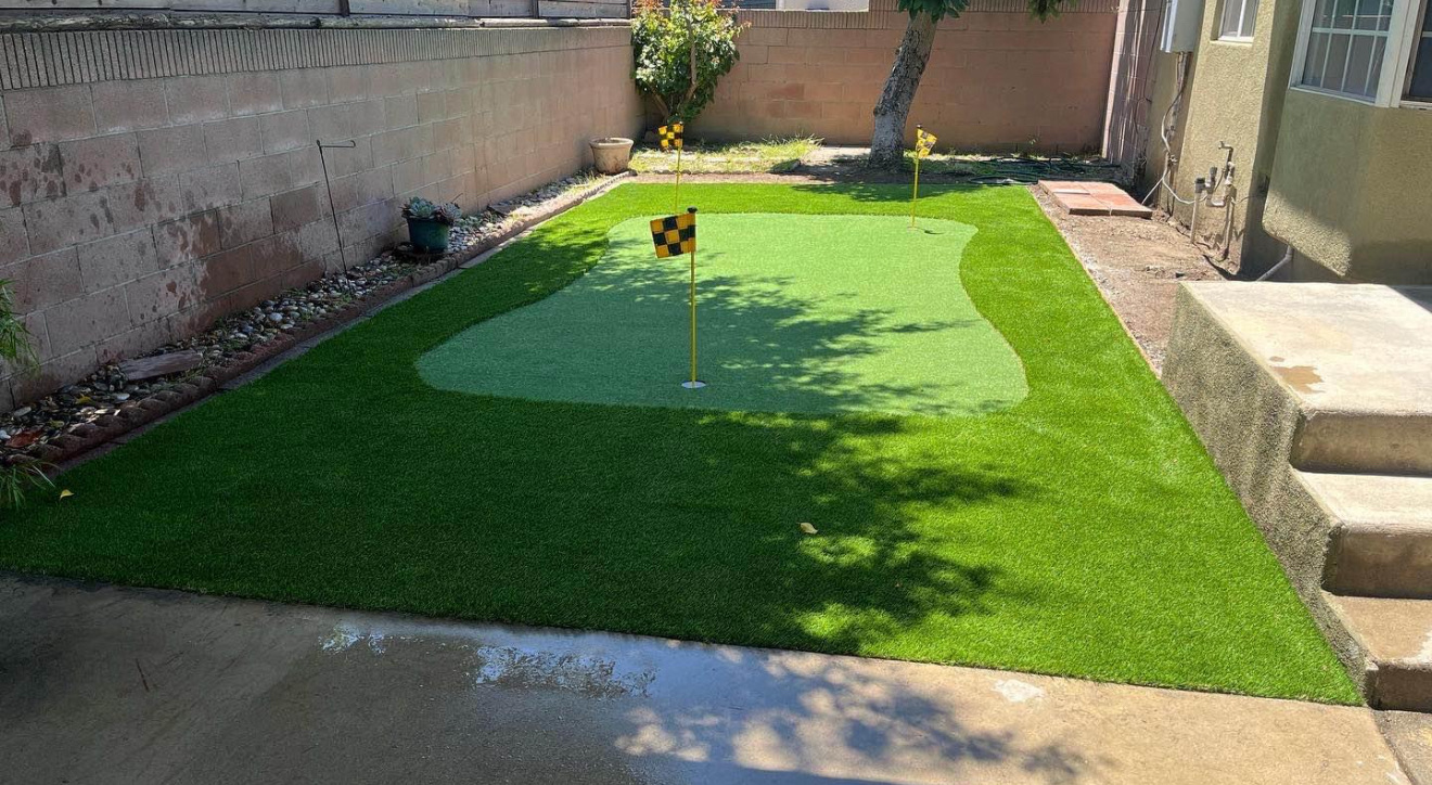 Finished backyard putting green with turf surround and flags